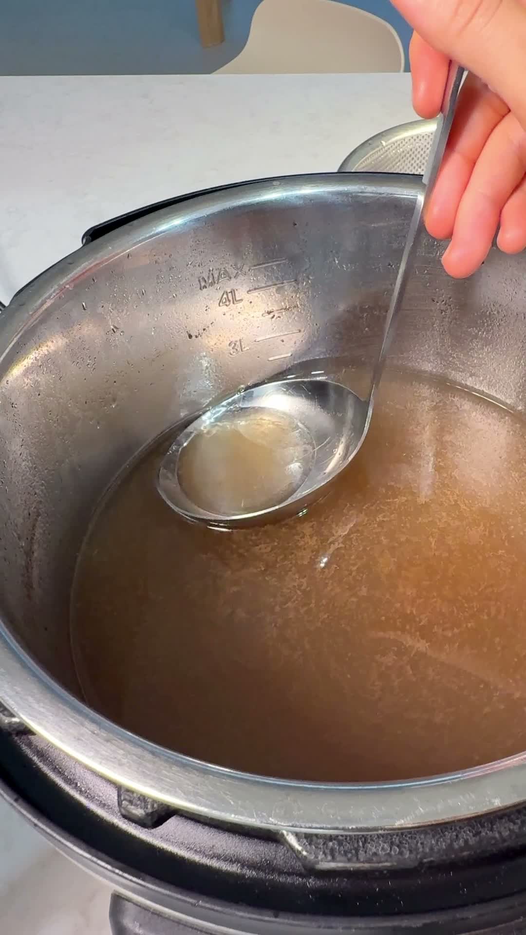 Skimming fat and impurities from the broth