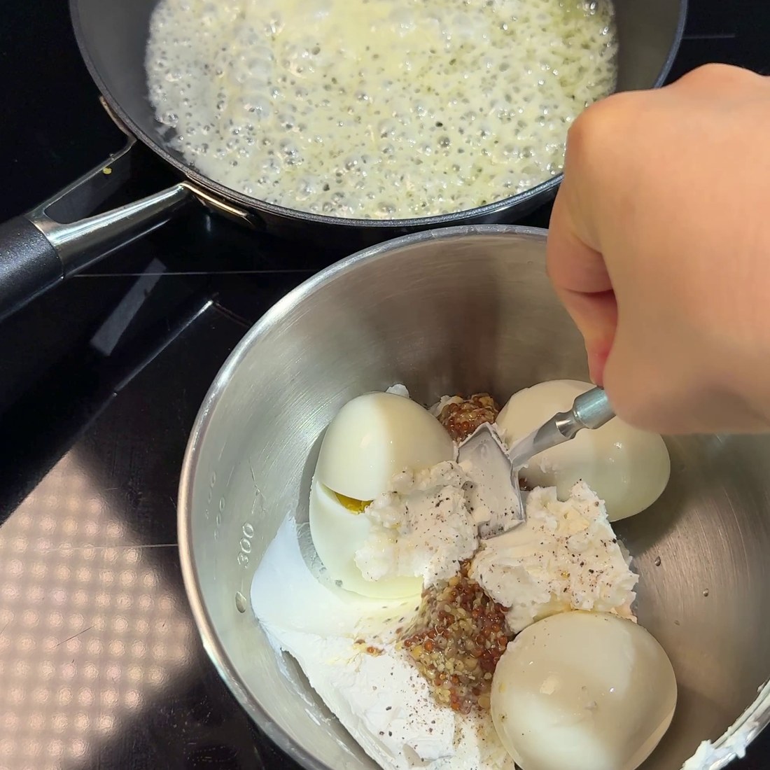 Yogurt, mustard, egg, and cucumber filling mixed in a bowl