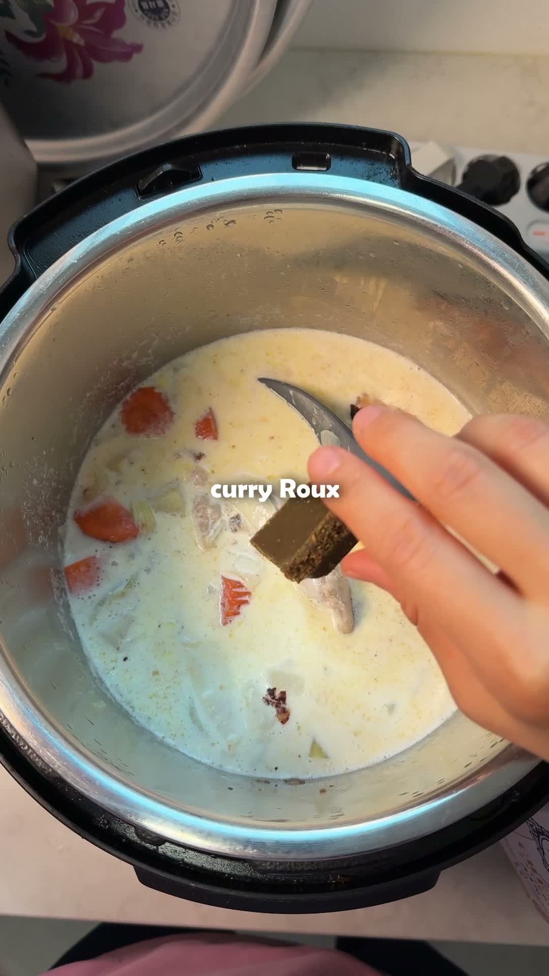 Curry roux cube added to the creamy chicken and vegetable stew