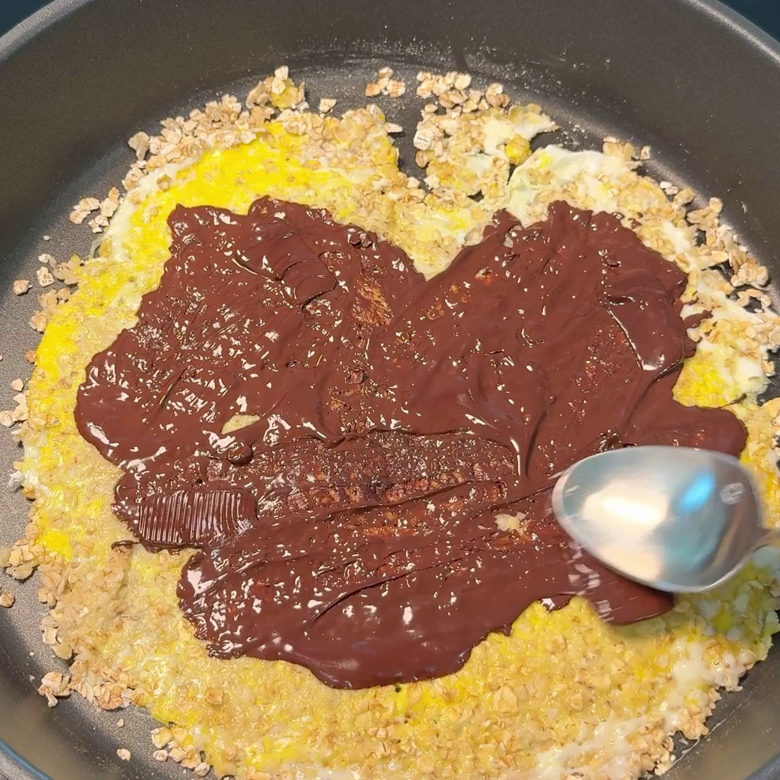 Chocolate pieces melting and spread across the crepe