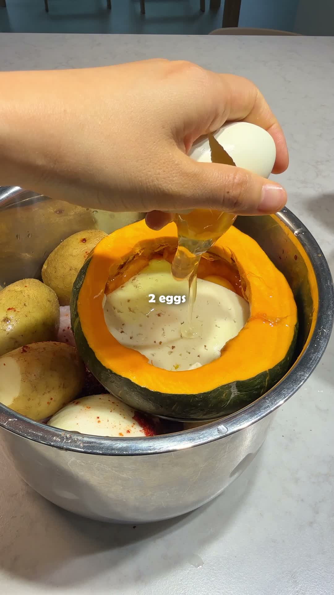 Eggs poured into a hollowed sweet pumpkin with king oyster mushroom alongside