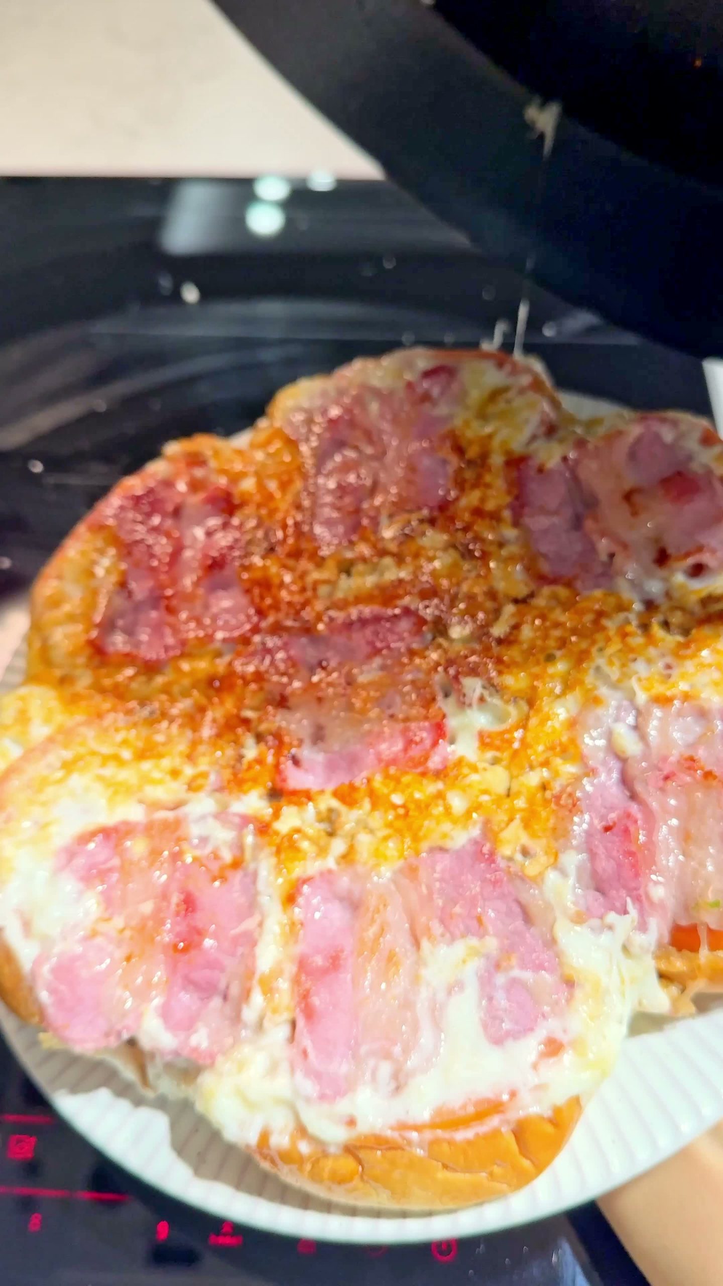Flipped dinner roll pizza plated, golden and cheesy