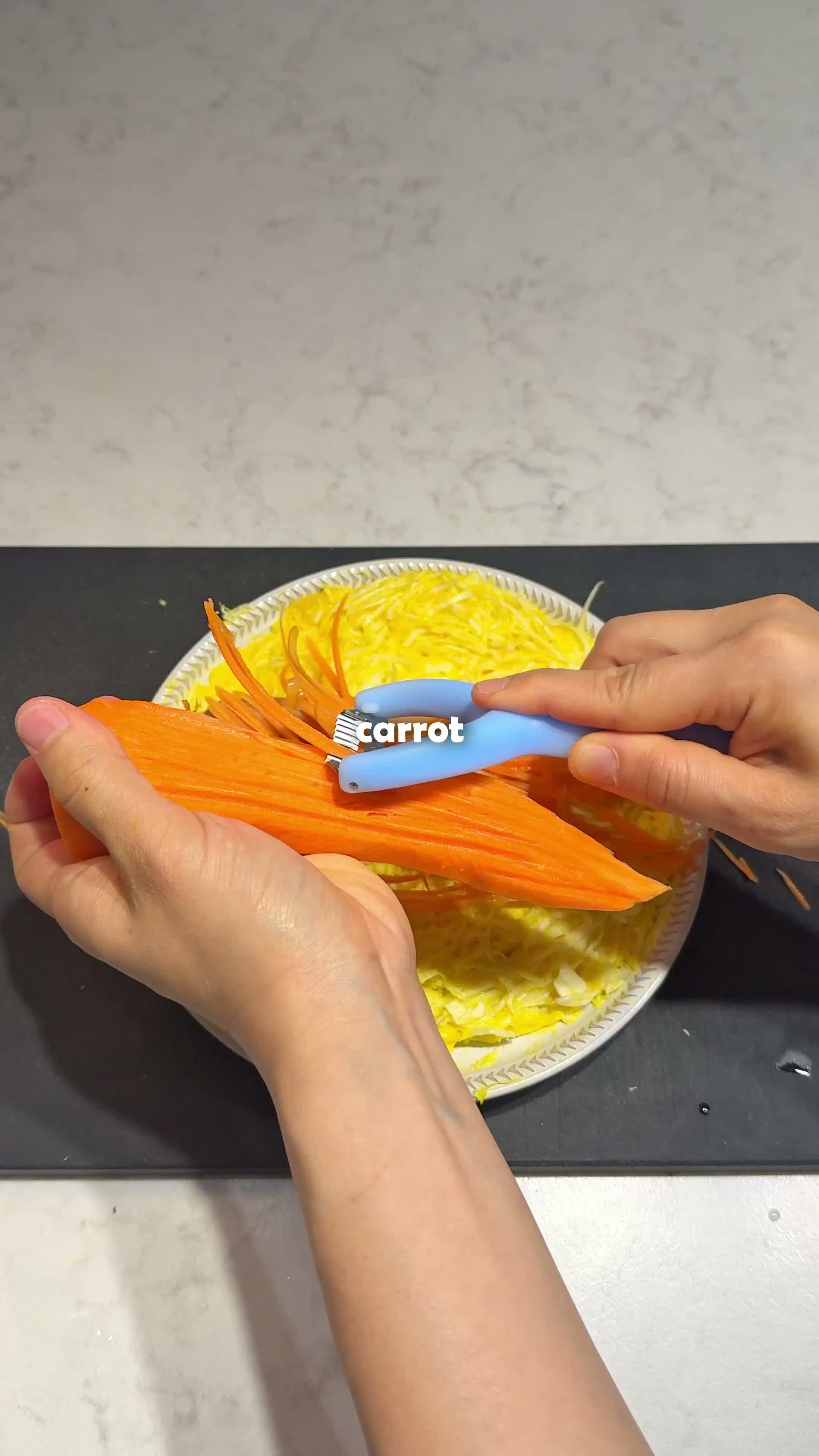 Shredded carrot and cucumber added on top of the cooked egg base