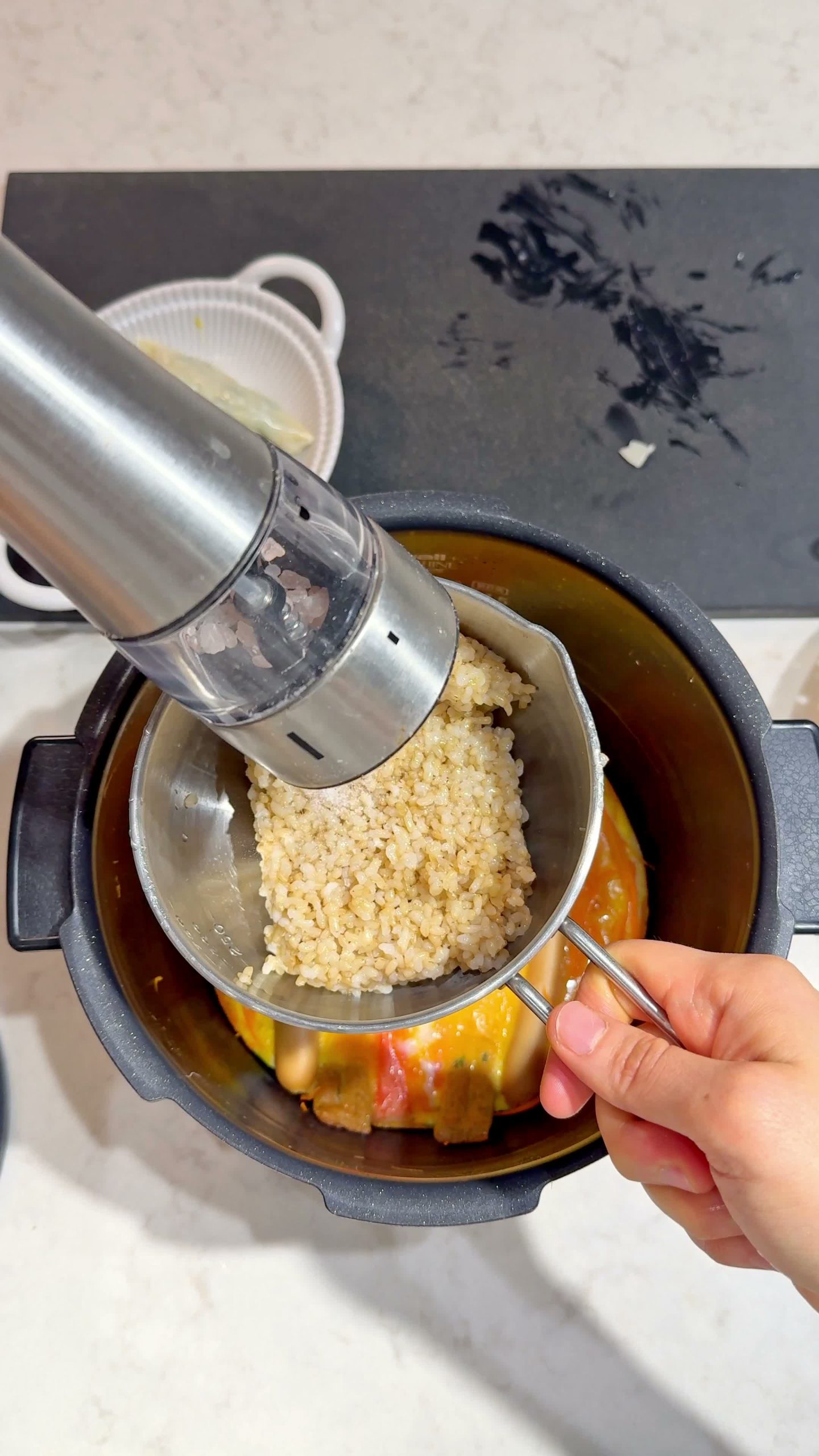 Sesame oil being poured over the cooked rice