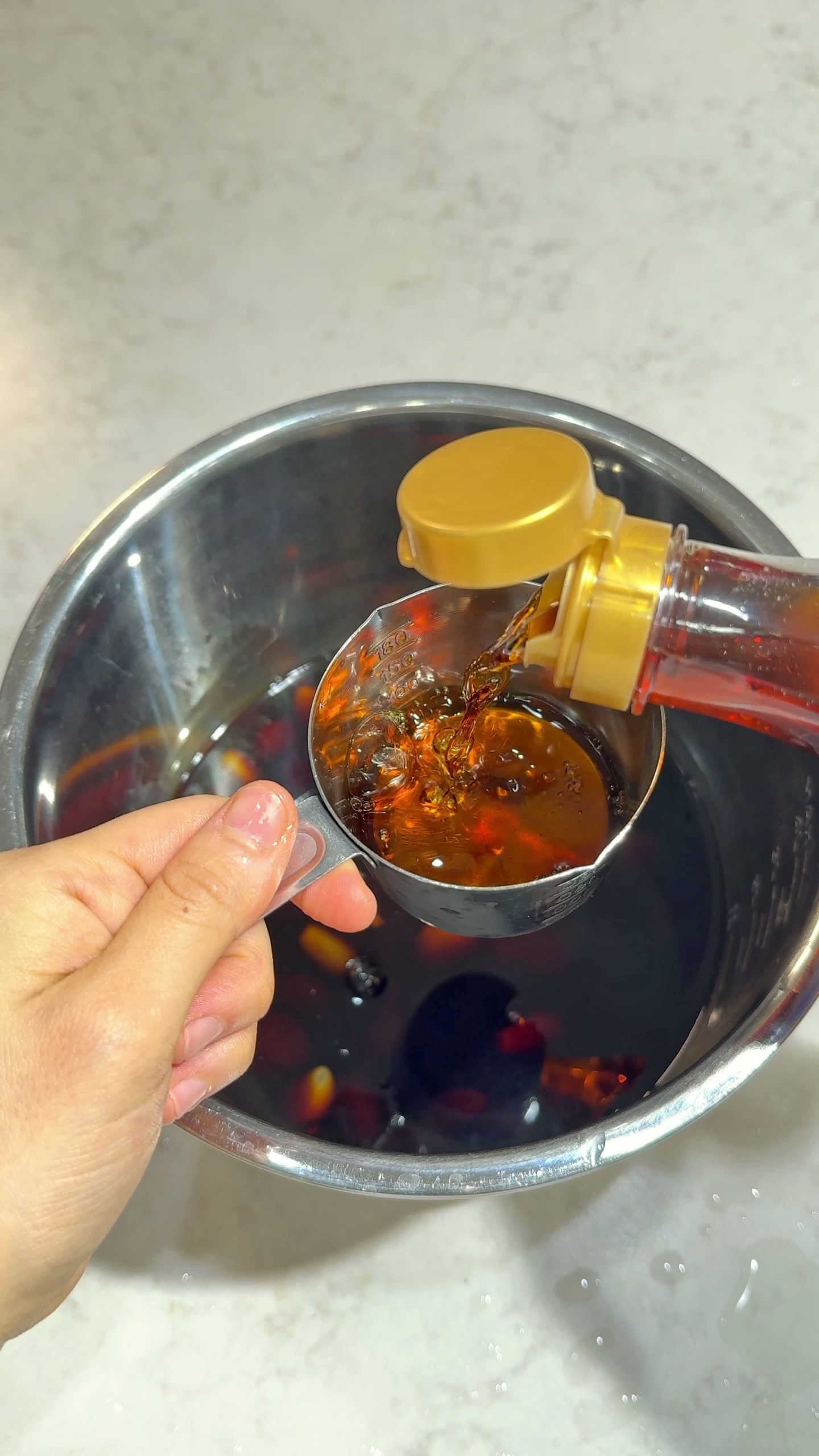 Sweetener being poured into the cola-garlic marinade liquid