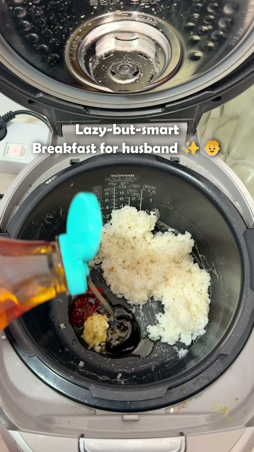 Rice, sambal sauce, and shrimp added to the rice cooker