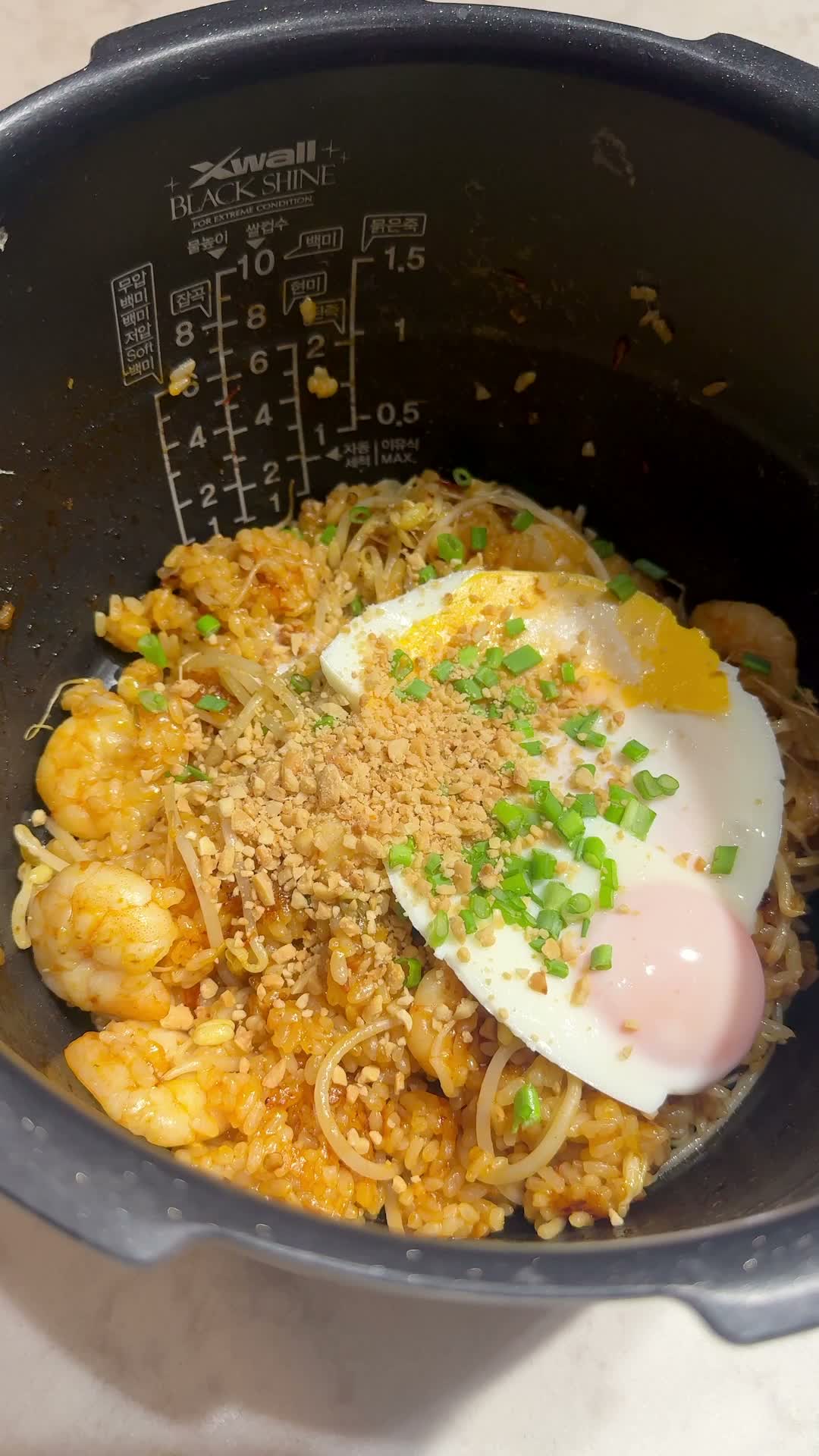 Steamed eggs placed on top of the mixed nasi goreng