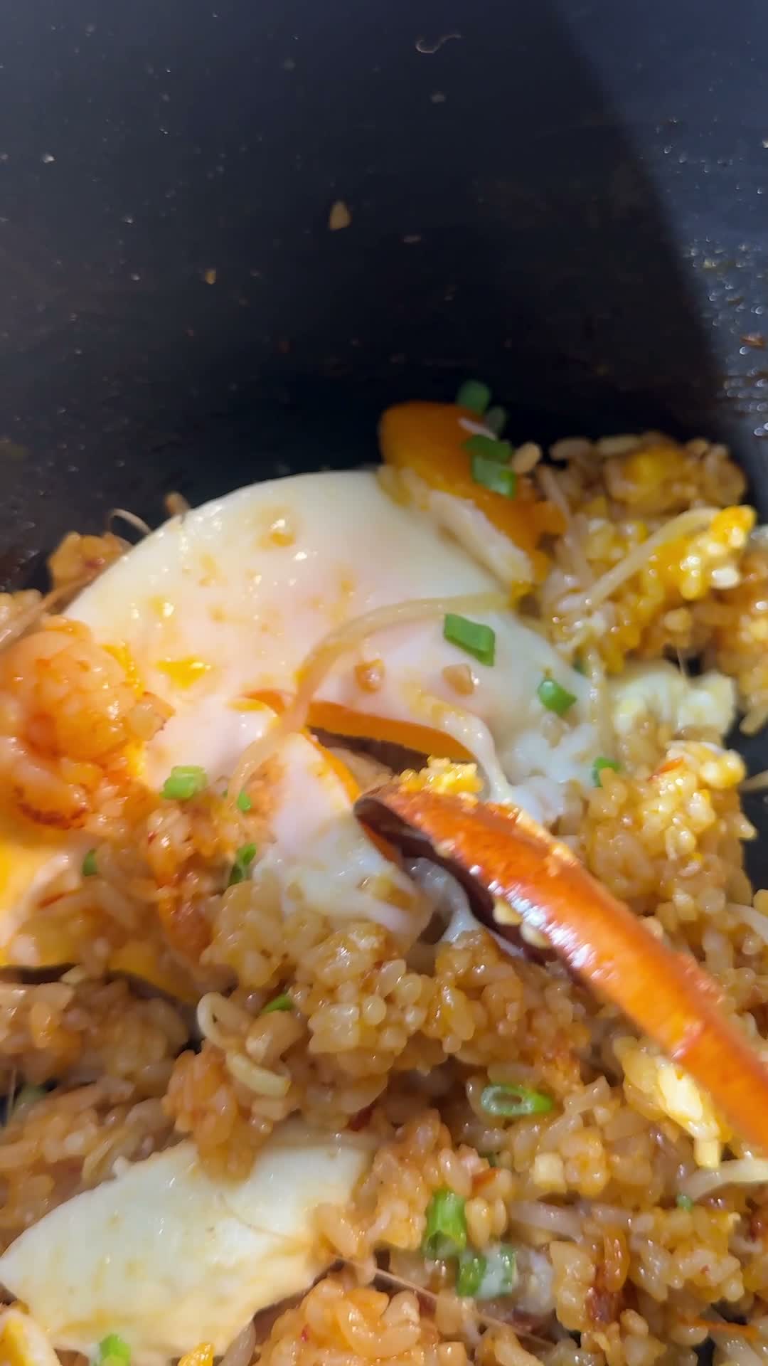 Finished nasi goreng garnished with chives and crushed peanuts