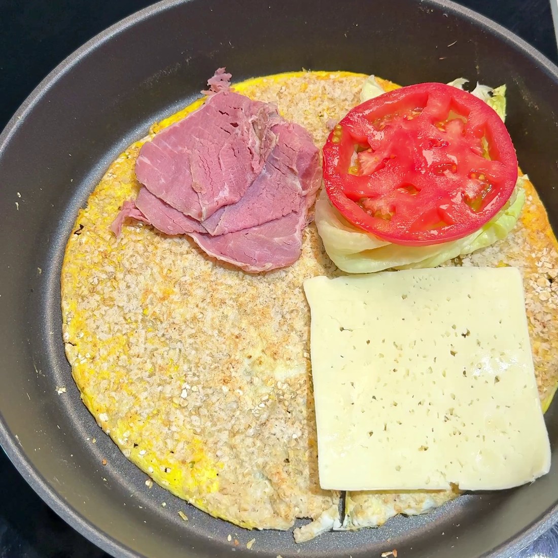 Ham, lettuce, tomato, and cheese arranged on one half
