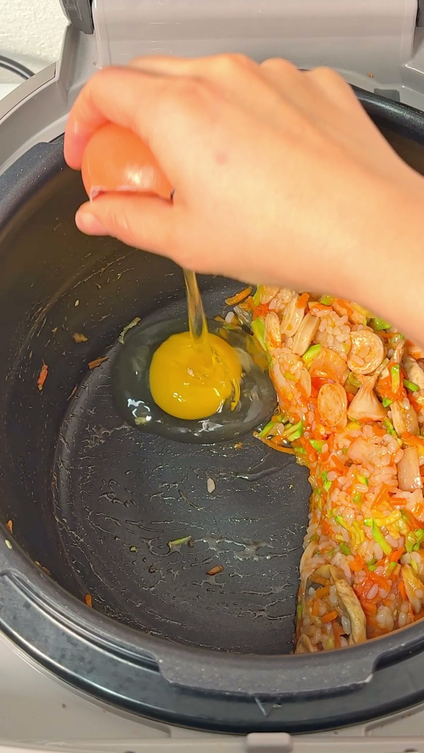 Egg cracked on top of the fried rice