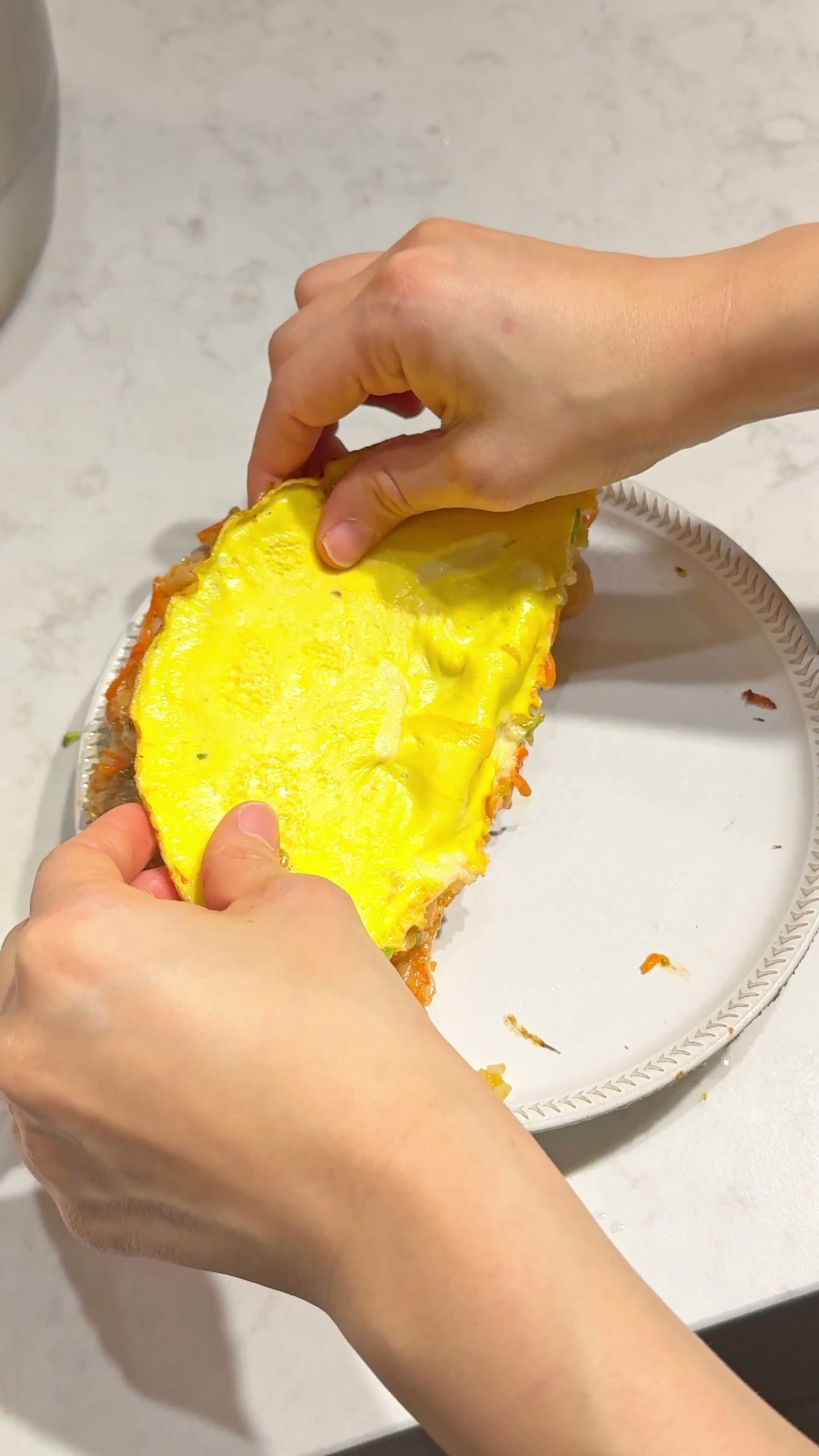 Omurice flipped onto a plate, egg-side up