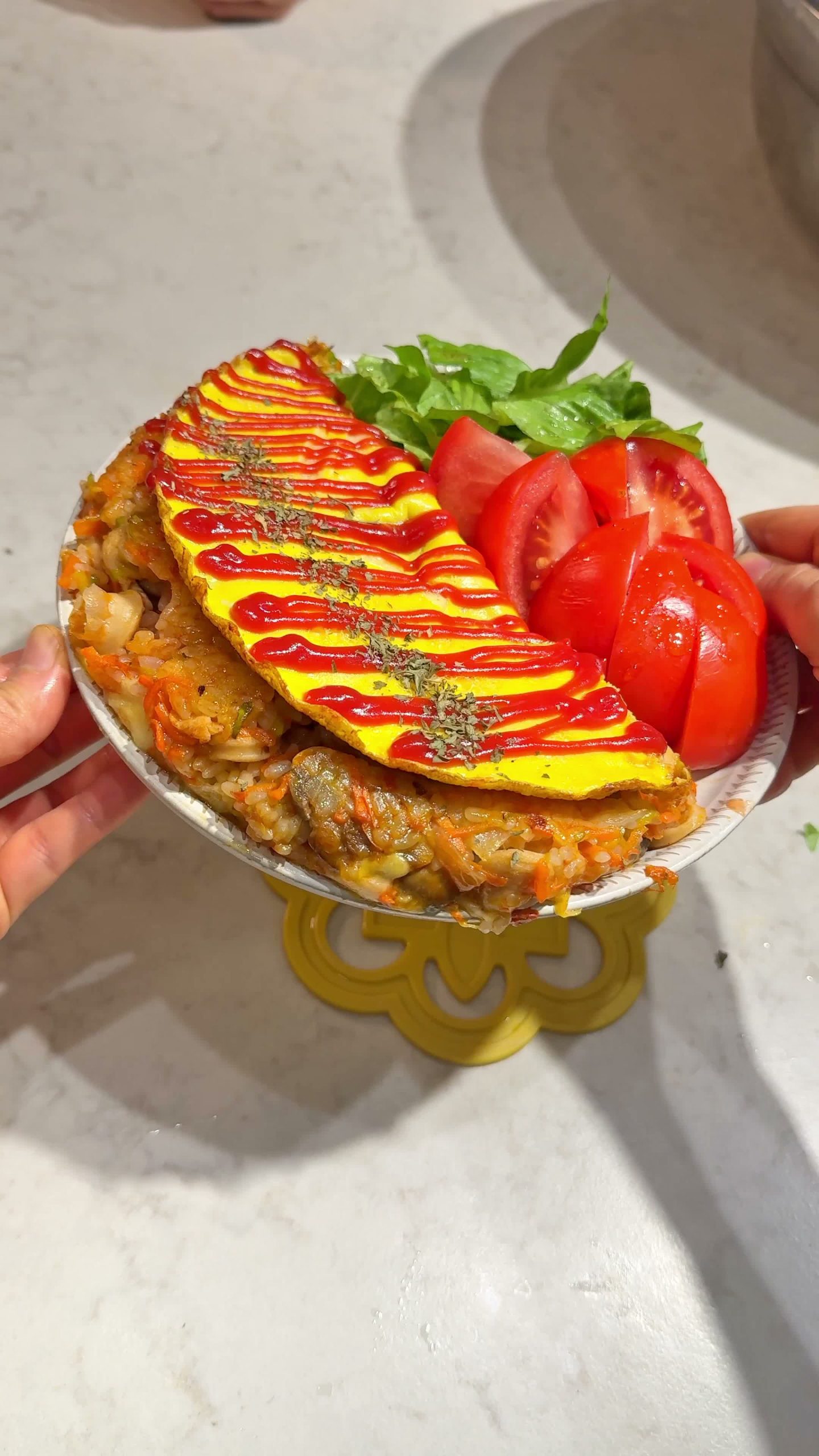 Ketchup drizzled over the finished omurice