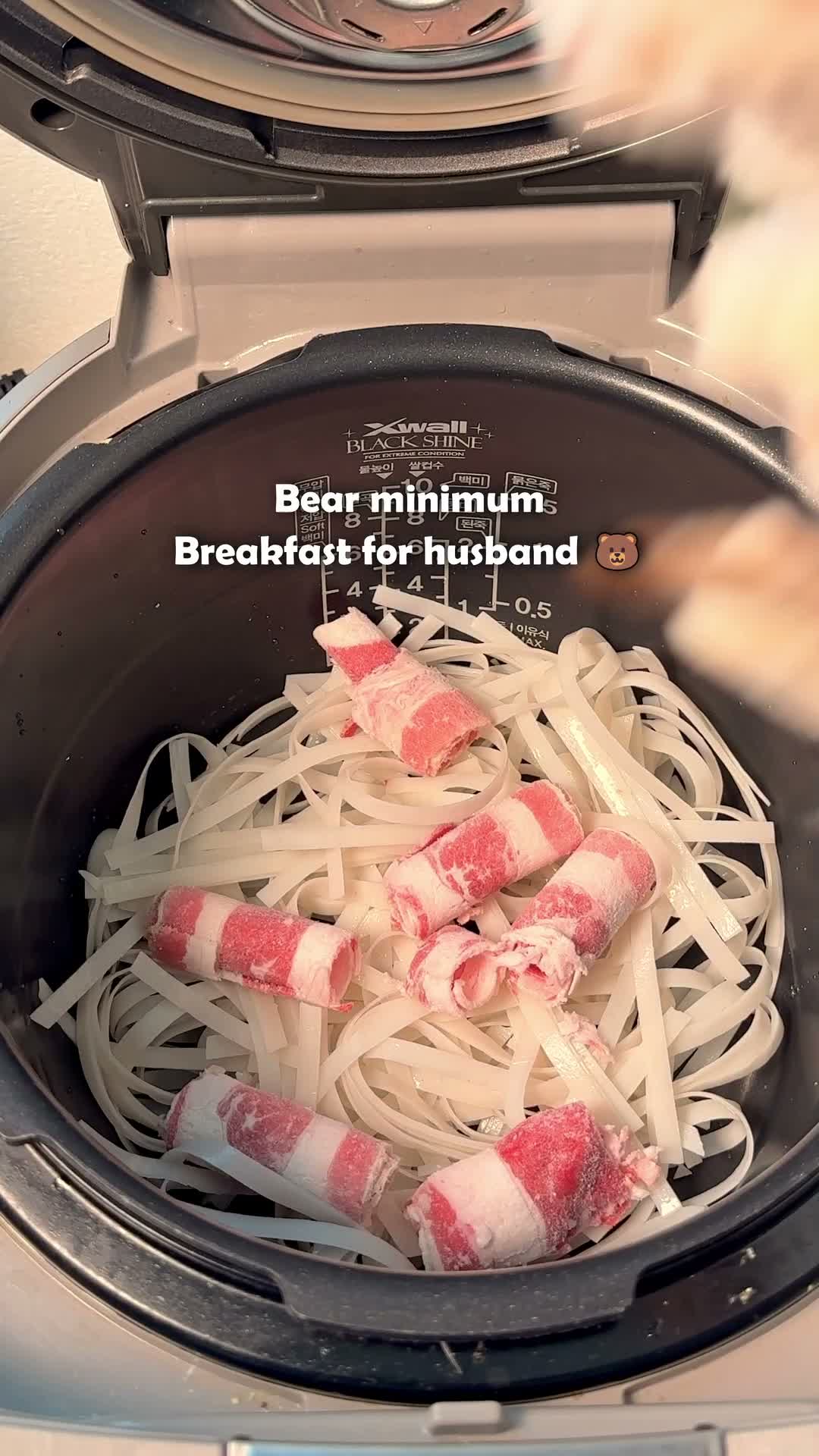 Pre-soaked rice noodles topped with rolled beef brisket in the rice cooker