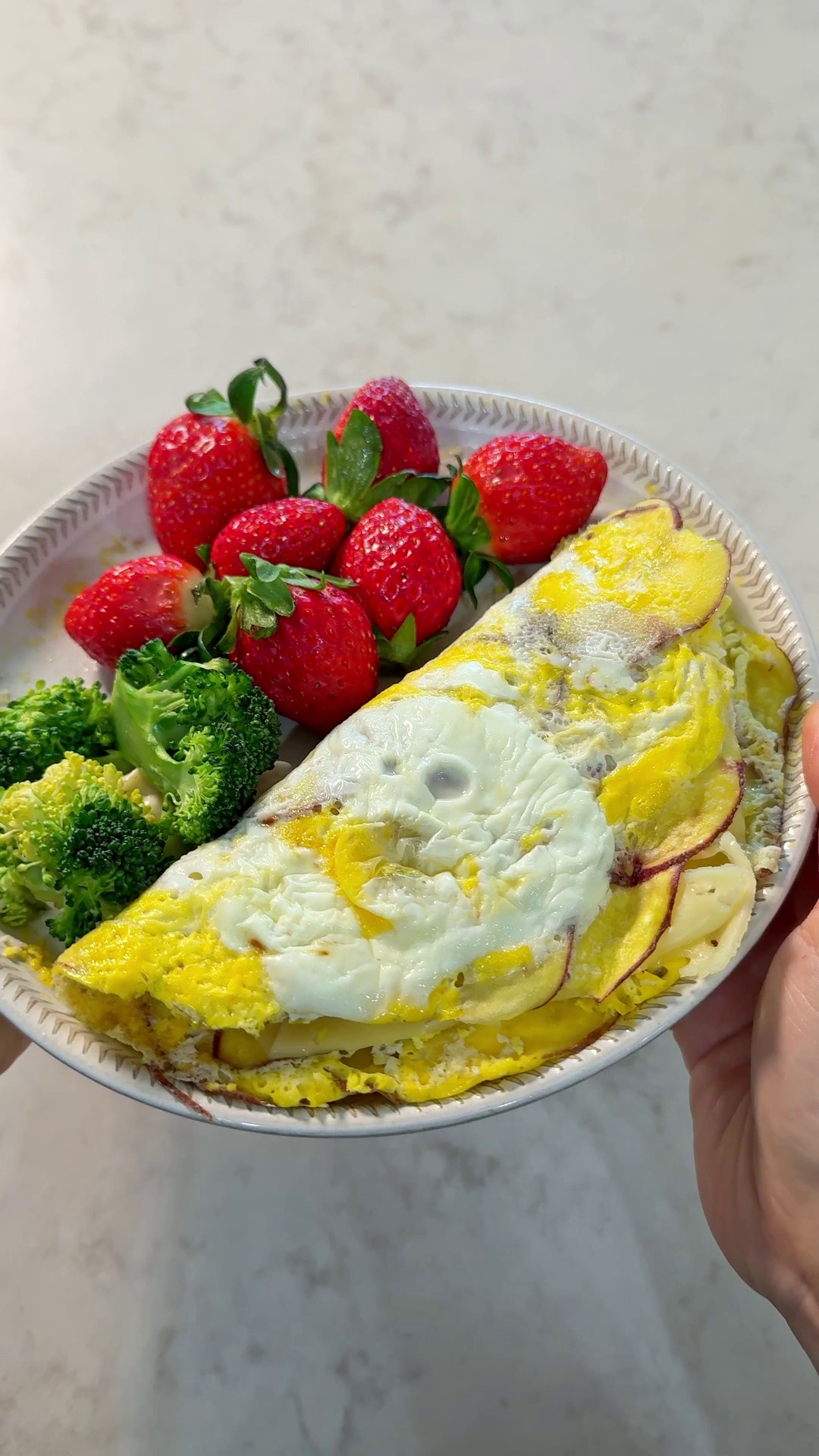 Potato egg paper folded in half with cheese and ham inside