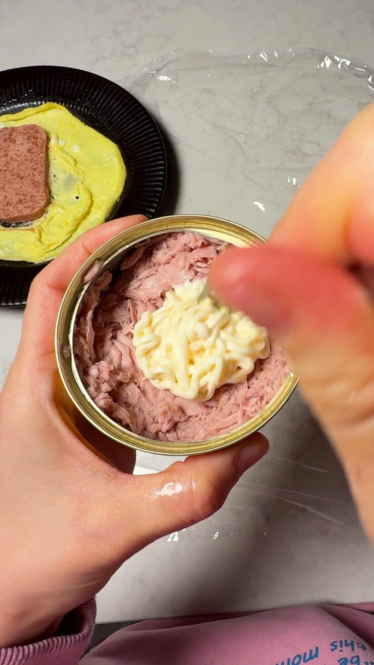 Mixing canned tuna with mayonnaise
