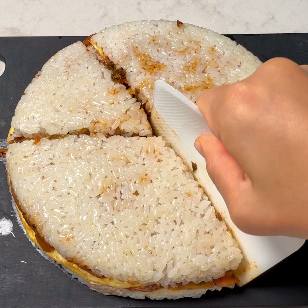 The rice disc flipped onto a cutting board and cut into 6 wedges, before wrapping