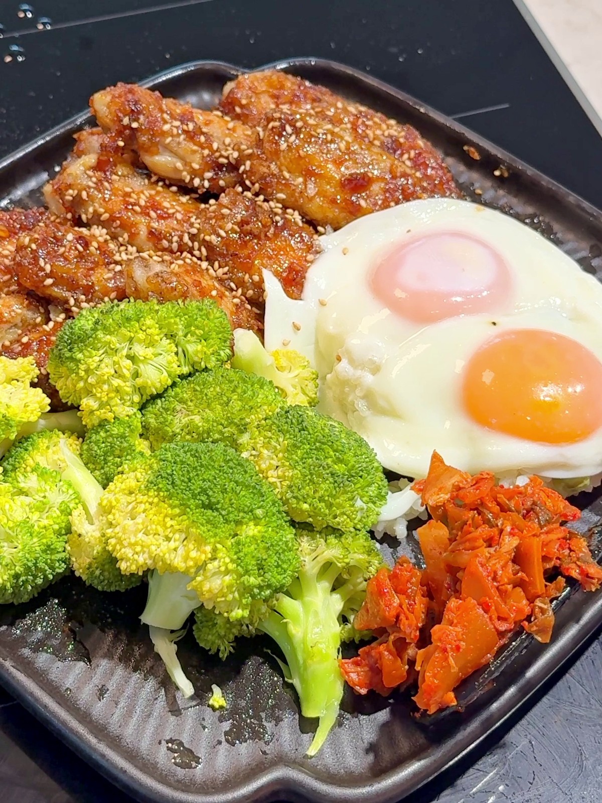 Glazed soy sauce chicken wings with broccoli, egg, and rice