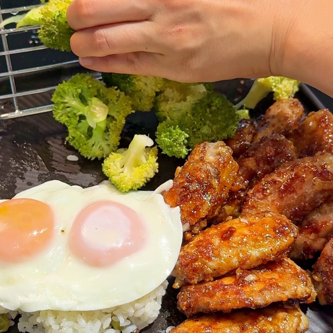 Chicken tossed in the glaze and plated with rice, egg, and broccoli