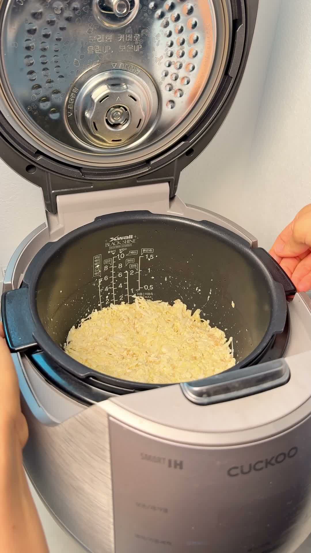 Mashed tofu and cabbage mixture in the rice cooker pot, ready to cook
