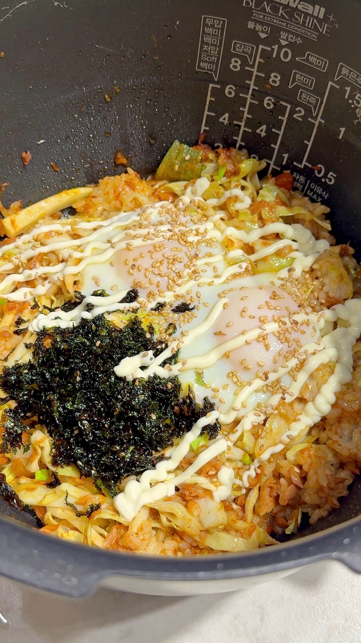 Seaweed flakes, mayonnaise, and sesame seeds topped over the cooked rice