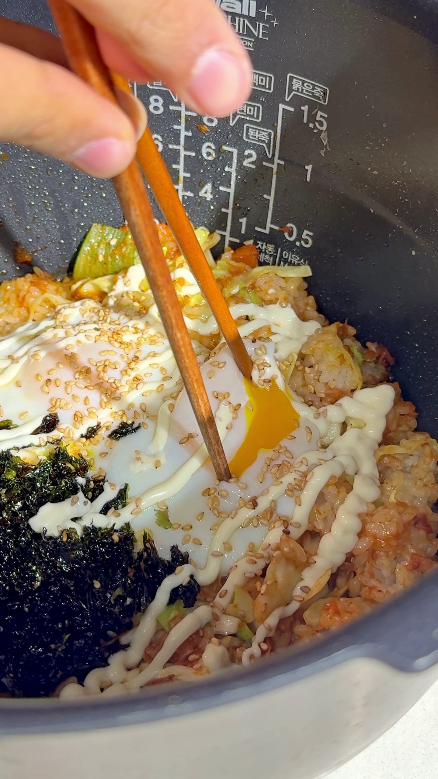 Toasted sesame seeds sprinkled over the finished dish with a runny egg yolk