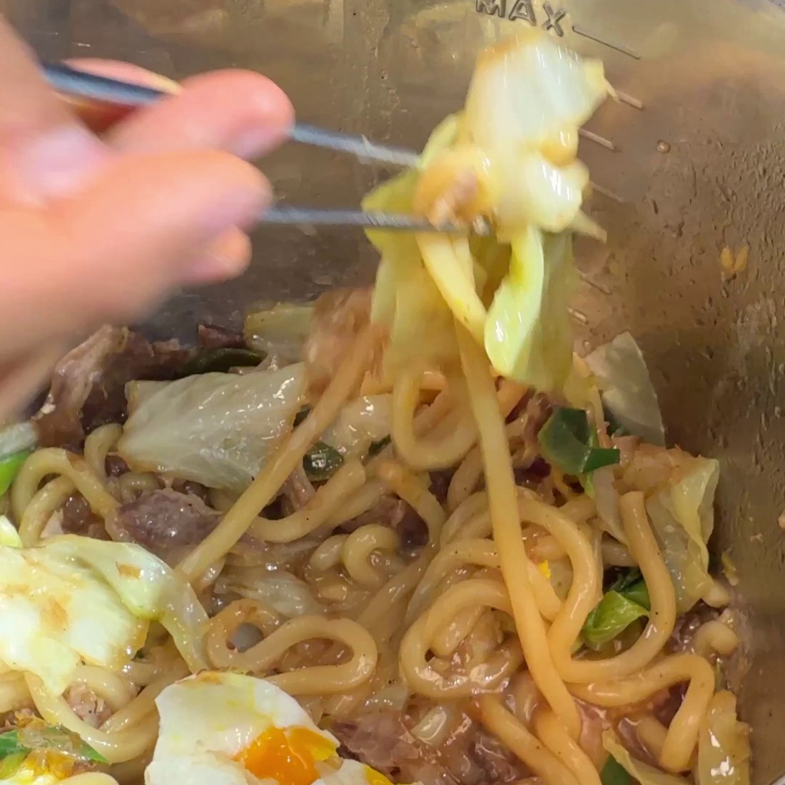 Yaki udon tossed and topped with bonito flakes and egg