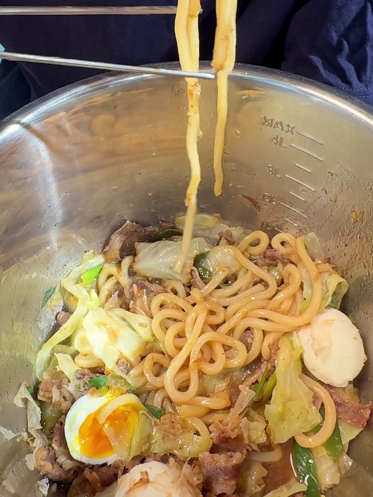 Yaki udon tossed with beef, cabbage, bonito flakes, and egg