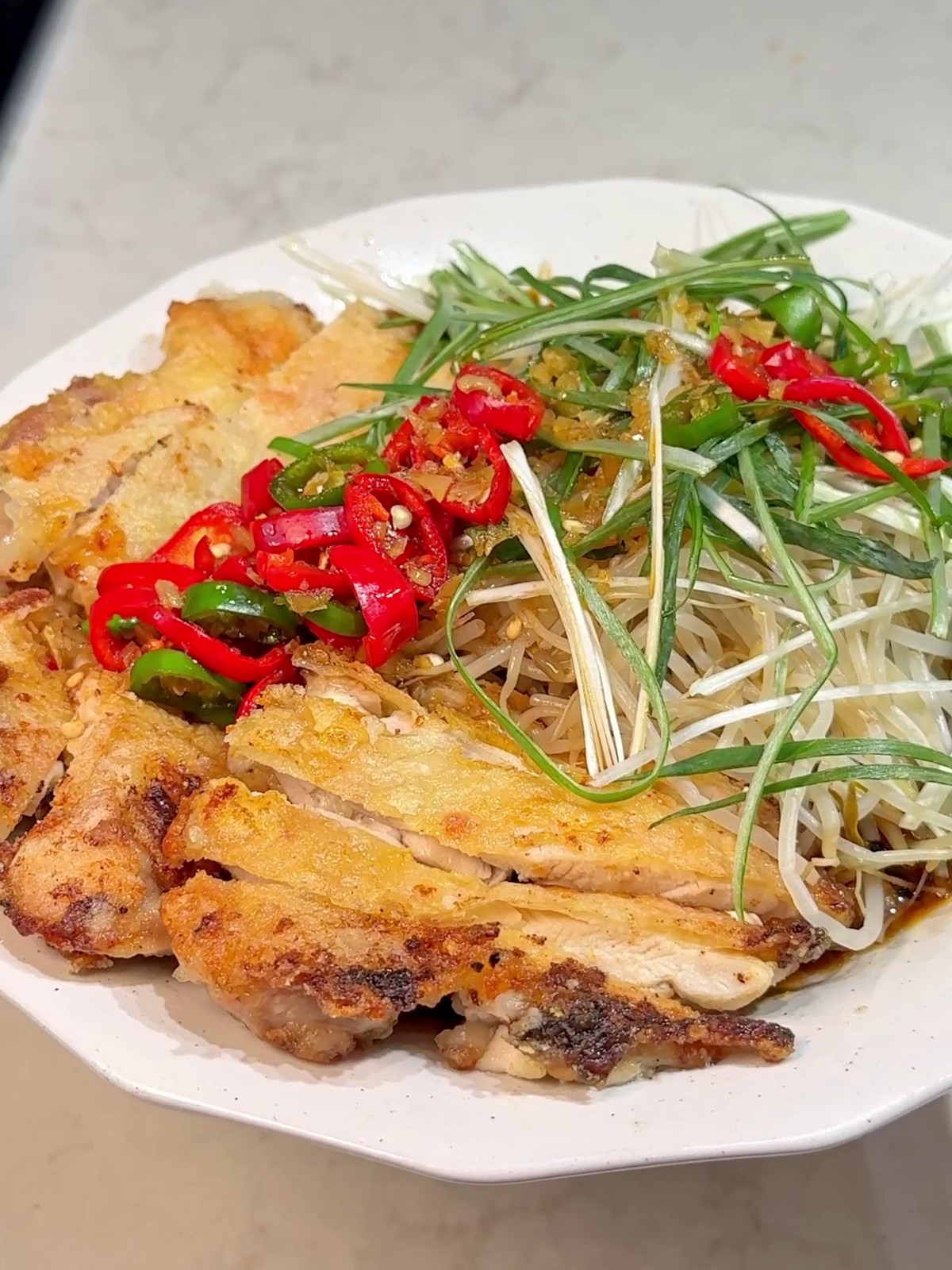 Crispy chicken yuringi rice bowl with bean sprouts and chili
