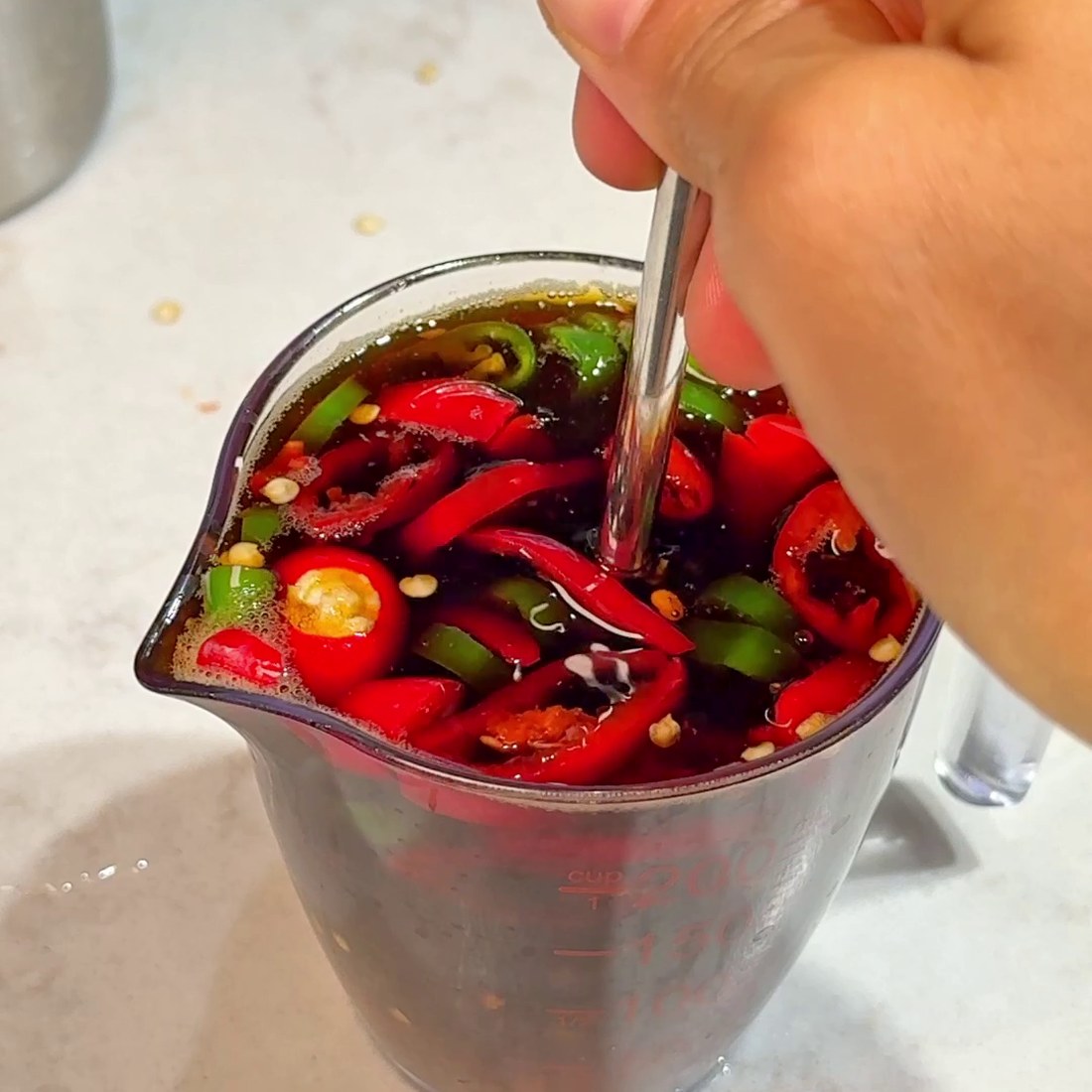Sauce ingredients mixed with sliced chili peppers